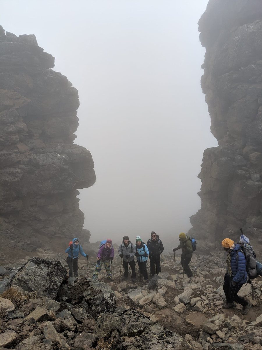 Climbers moving through Kilimanjaro rock formations