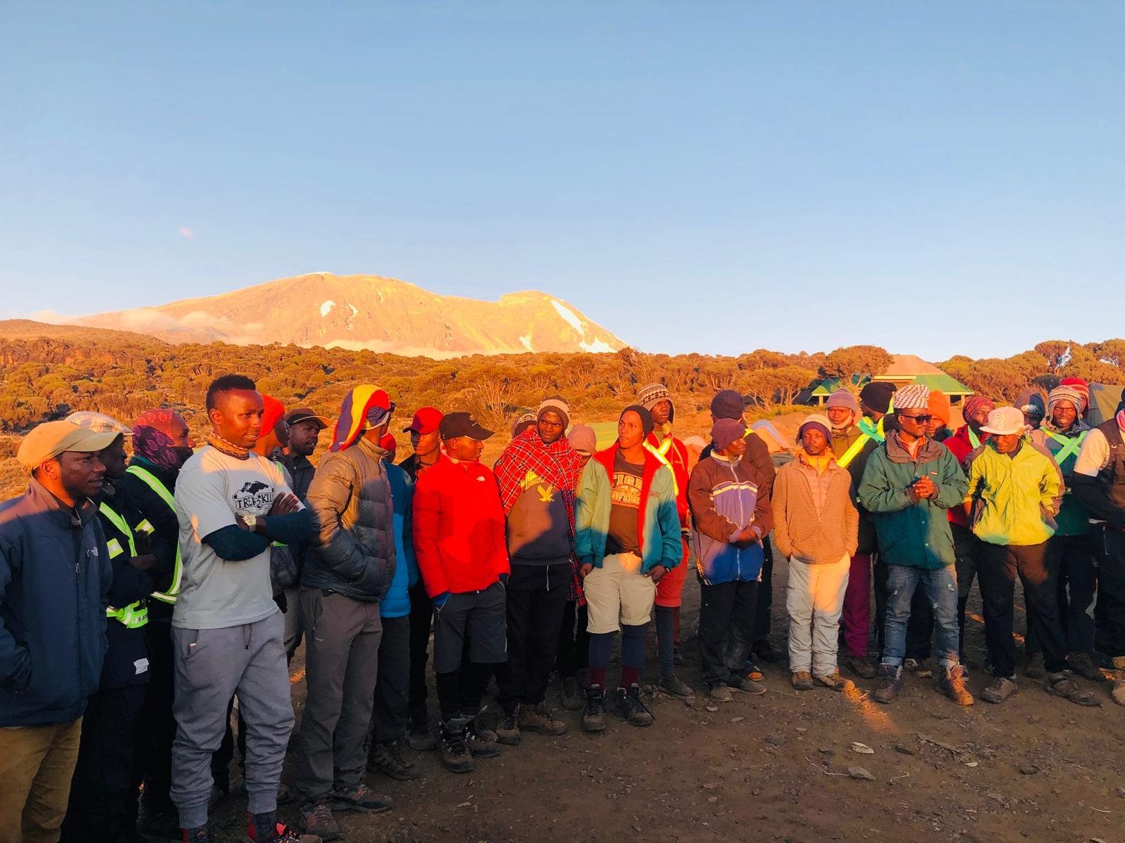 Bright group photo with mountain crew before a Kilimanjaro climb